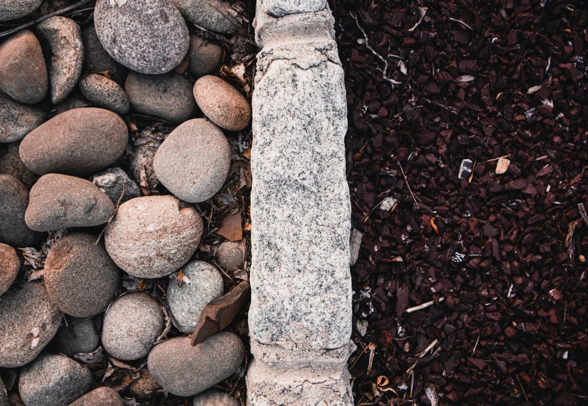 Comparison chart showing durability, cost, and installation difficulty of metal, stone, brick, and plastic garden edging materials